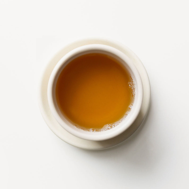 A cup of Iron Goddess of Mercy tea from Rishi Tea & Botanicals on a white background.