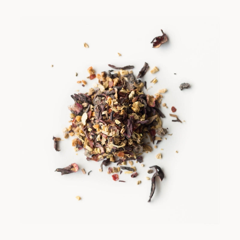 A pile of Rishi Tea & Botanicals' Tangerine Ginger tea leaves on a white background.