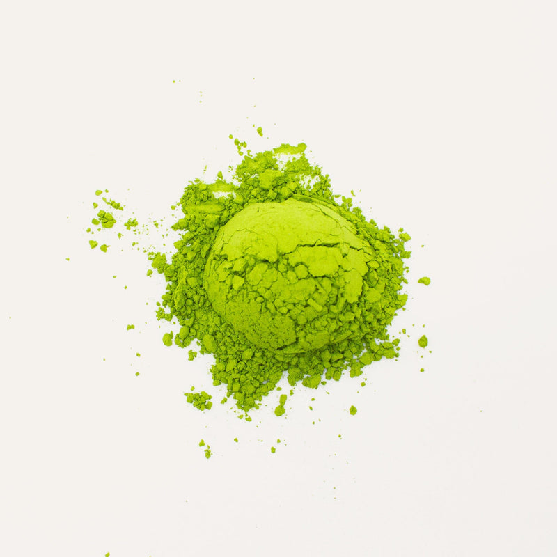 Nishi San's Matcha Asanoka by Rishi Tea & Botanicals, known for its alpine aroma, forms a vibrant green powder pile on a white background and is rich in amino acids.